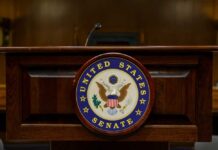 Podium with the United States Senate seal in a formal setting
