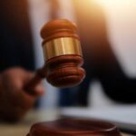 Classified Chaos: Deal Raises Eyebrows A judge's gavel being raised in a courtroom setting