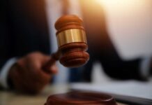 Classified Chaos: Deal Raises Eyebrows A judge's gavel being raised in a courtroom setting