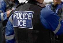 ICE Refuses Virginia’s New Mask Rule Close-up of a police officer's vest with 'POLICE ICE' label