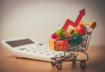 City-Backed Stores Dodge Rent, Crush Neighbors A shopping cart filled with colorful grocery items next to a calculator and an upward trend arrow