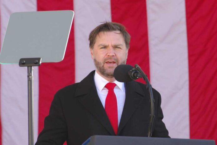 Arlington,,Va,-,November,11,,2025:,U.s.,Vice,President,Jd Man speaking at a podium with an American flag backdrop