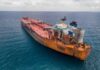 Pentagon Power Move Freezes Iran-Bound Tanker Aerial view of a large, rusty oil tanker in the ocean