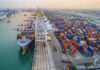 UN Alarm: Hunger Wave Incoming Aerial view of a busy shipping port with cargo containers and a large ship