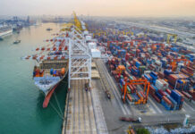 UN Alarm: Hunger Wave Incoming Aerial view of a busy shipping port with cargo containers and a large ship