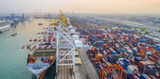 Aerial view of a busy shipping port with cargo containers and a large ship