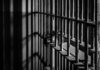 Iran Prison Horror: U.S. Reporter Trapped Close-up of prison bars casting shadows on a wall