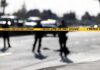 Prison Term Follows Deadly Pileup Police tape cordons off a street with blurred officers and vehicles in the background