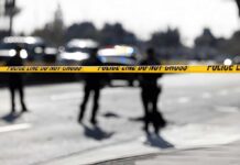 Prison Term Follows Deadly Pileup Police tape cordons off a street with blurred officers and vehicles in the background