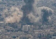 Iran Reports Troops Killed In Strikes Smoke rising from a city in a mountainous area