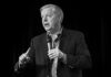 Washington Mourns Senator Lindsey Graham Man in a suit speaking into a handheld microphone