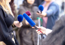 Reporter Privilege Faces Major Court Test Reporters holding microphones during an interview