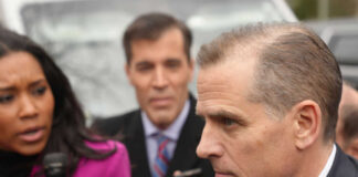 A journalist interviewing a political figure outdoors