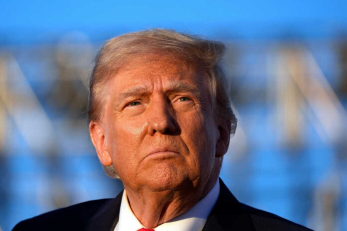 Close-up portrait of a serious-looking political figure outdoors