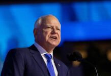Sex Crime Pardon Fuels Immigration Fight A government official delivering a speech at a podium with a blue background