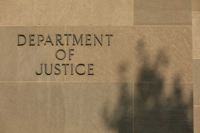 shutterstock2557865709jpg Sign reading Department of Justice on a stone wall with a shadow