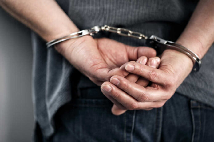 shutterstock258602471jpg Hands cuffed behind the back, indicating arrest