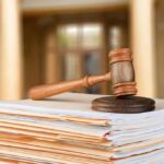 Boxcar Deaths Expose D.C. Breakdown judge's gavel resting on a stack of case files