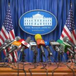 Press microphones at a White House briefing podium