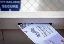 Trump Wins Key Election Court Battle Mail-in ballot being inserted into a secure drop box slot