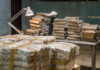 Cartel Claims Rock Mexican Politics Stacks of packaged goods in a dimly lit warehouse