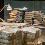 Stacks of packaged goods in a dimly lit warehouse