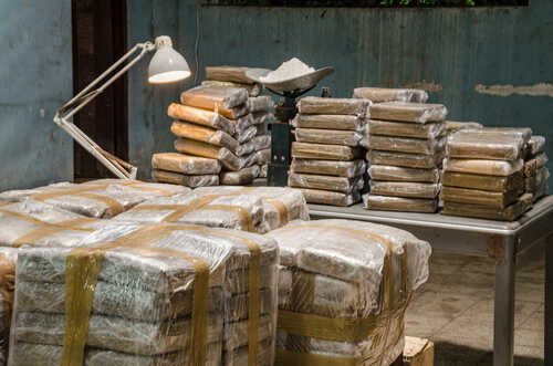 Cocaine,Warehouse,Illegal,Drug,Production Stacks of packaged goods in a dimly lit warehouse