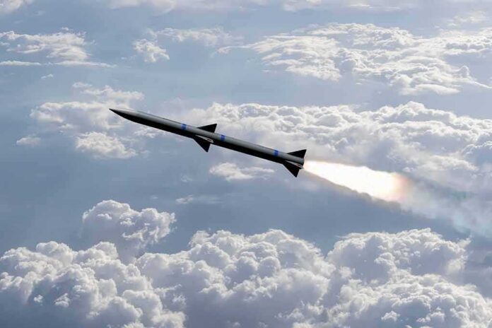 Rocket flying above clouds with bright exhaust plume