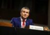 Hegseth Reverses Apache Pilot Suspensions Man in a blue suit speaking at a government hearing