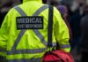 Backpack Bomb Shocks Luxury Haven Medical first responder wearing a bright yellow jacket and carrying a red bag