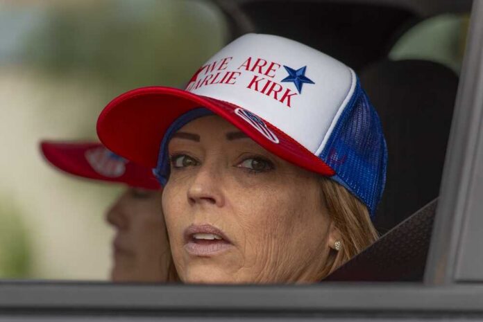 Glendale,,Arizona,,September,21,2025,,Attendees,At,The,Charlie,Kirk,Memorial A woman wearing a cap with a political message, looking out from a vehicle