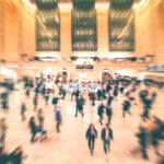 System Meltdown: Heat Exposes NJ Transit Failures A busy train station filled with blurred figures of people moving