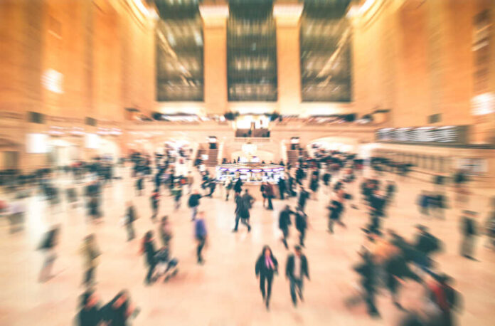 Grand,Central,,,New,York,City,At,Main,Hall,With A busy train station filled with blurred figures of people moving