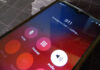 Cyberattack Cripples City Lifeline Phone screen showing 911 emergency call in progress.