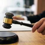 Mental Hospital Pass Turns Into Airport Getaway Judge's hand holding a gavel over a sound block