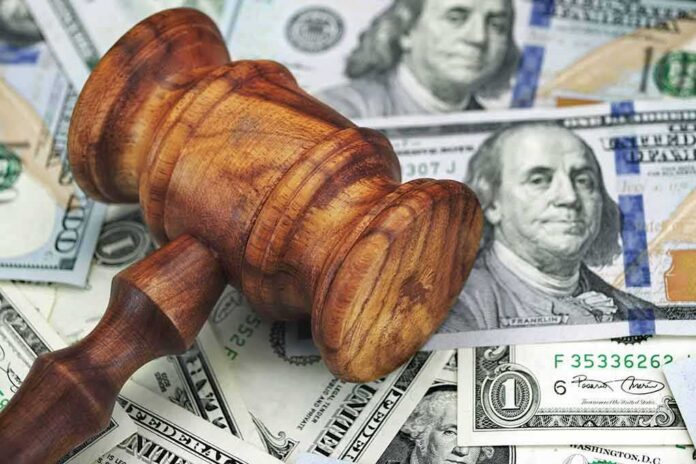 Wooden judge's gavel on scattered US dollar bills