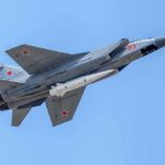Airspace Breach Sparks NATO Scramble fighter jet with missile flying against a clear blue sky