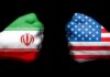 Ceasefire Claims, Iran Says “Not Final” Fists painted as Iran and United States flags facing each other