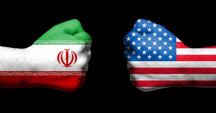 shutterstock_1086543533 Fists painted as Iran and United States flags facing each other