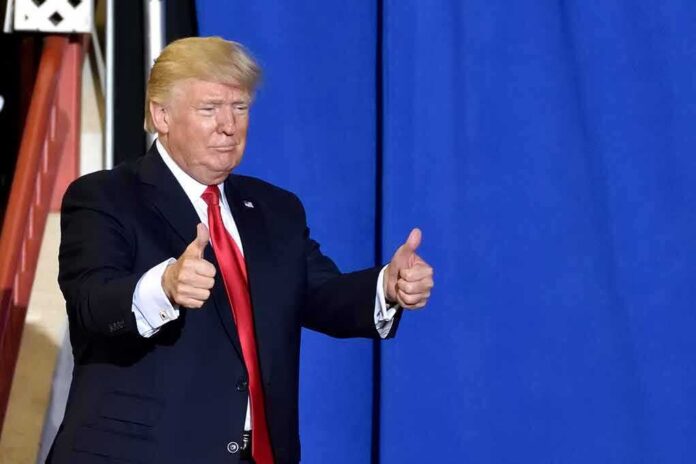 man in suit giving two thumbs up