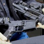 Washington’s Rifle Move Stirs Big Questions Person wearing gloves disassembling a rifle