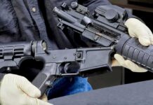 Washington’s Rifle Move Stirs Big Questions Person wearing gloves disassembling a rifle