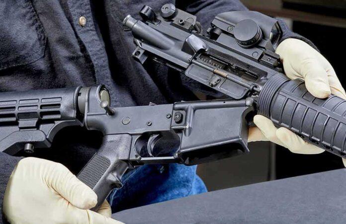 shutterstock_1088730455 Person wearing gloves disassembling a rifle