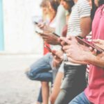 Democrats Test Drive Youth Whisperers Group of people using smartphones outdoors
