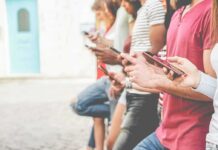 Group of people using smartphones outdoors
