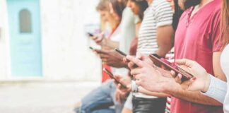 Group of people using smartphones outdoors