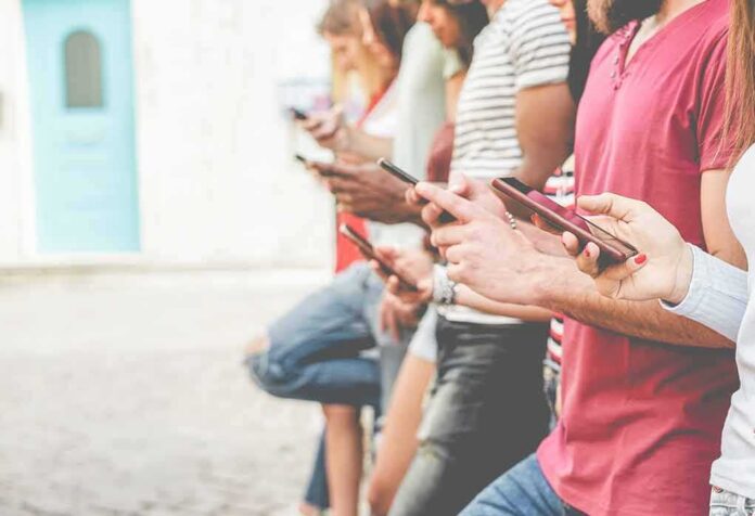 Group of people using smartphones outdoors