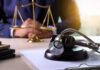 Gavel with stethoscope on desk near scales of justice