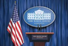 White House press briefing podium and US flag