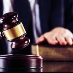 Suitcase Horror Shocks Brooklyn Court Judge's gavel striking block with hand on book in background